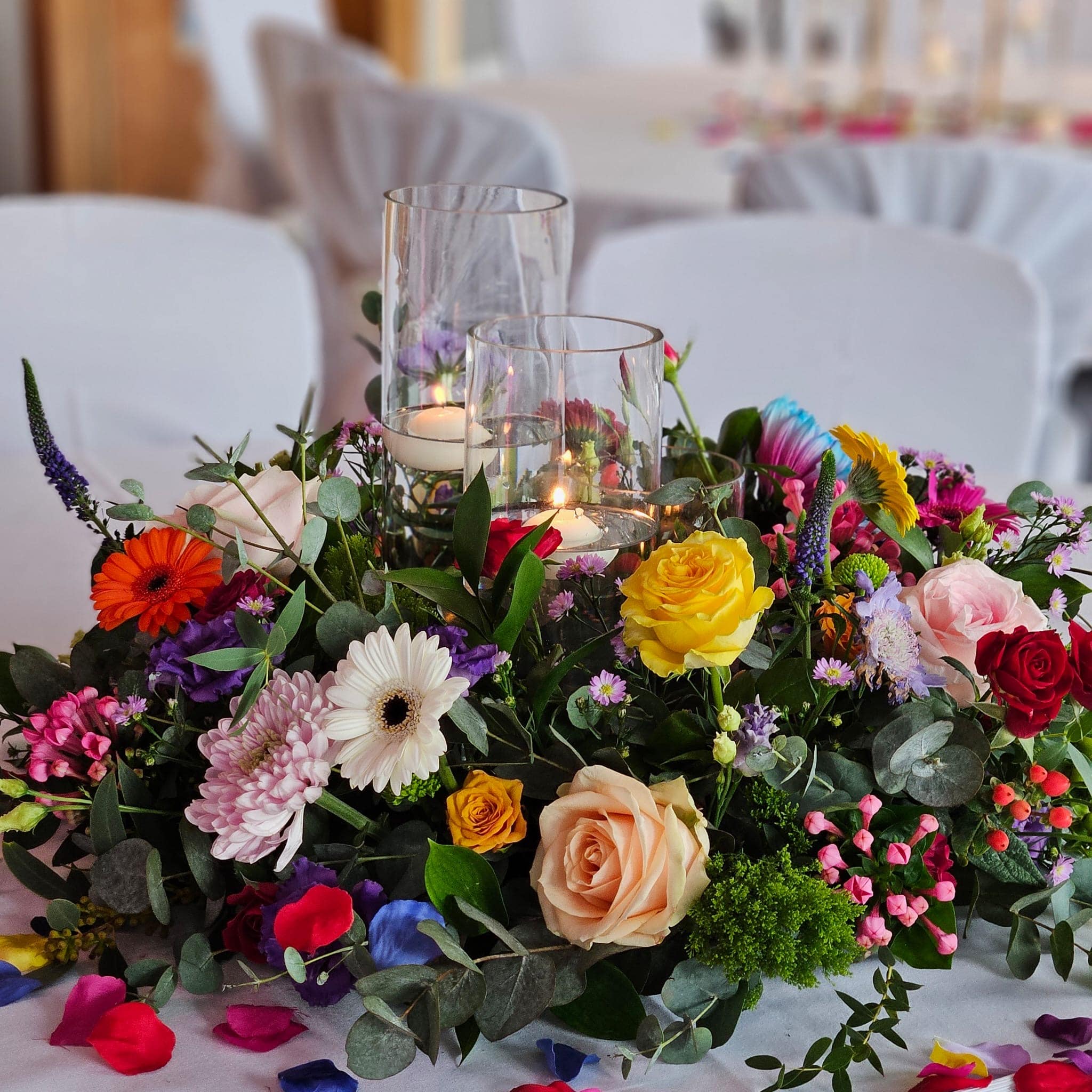 tables styled by venue stylist with flowers and candles. The wedding decor is beautiful