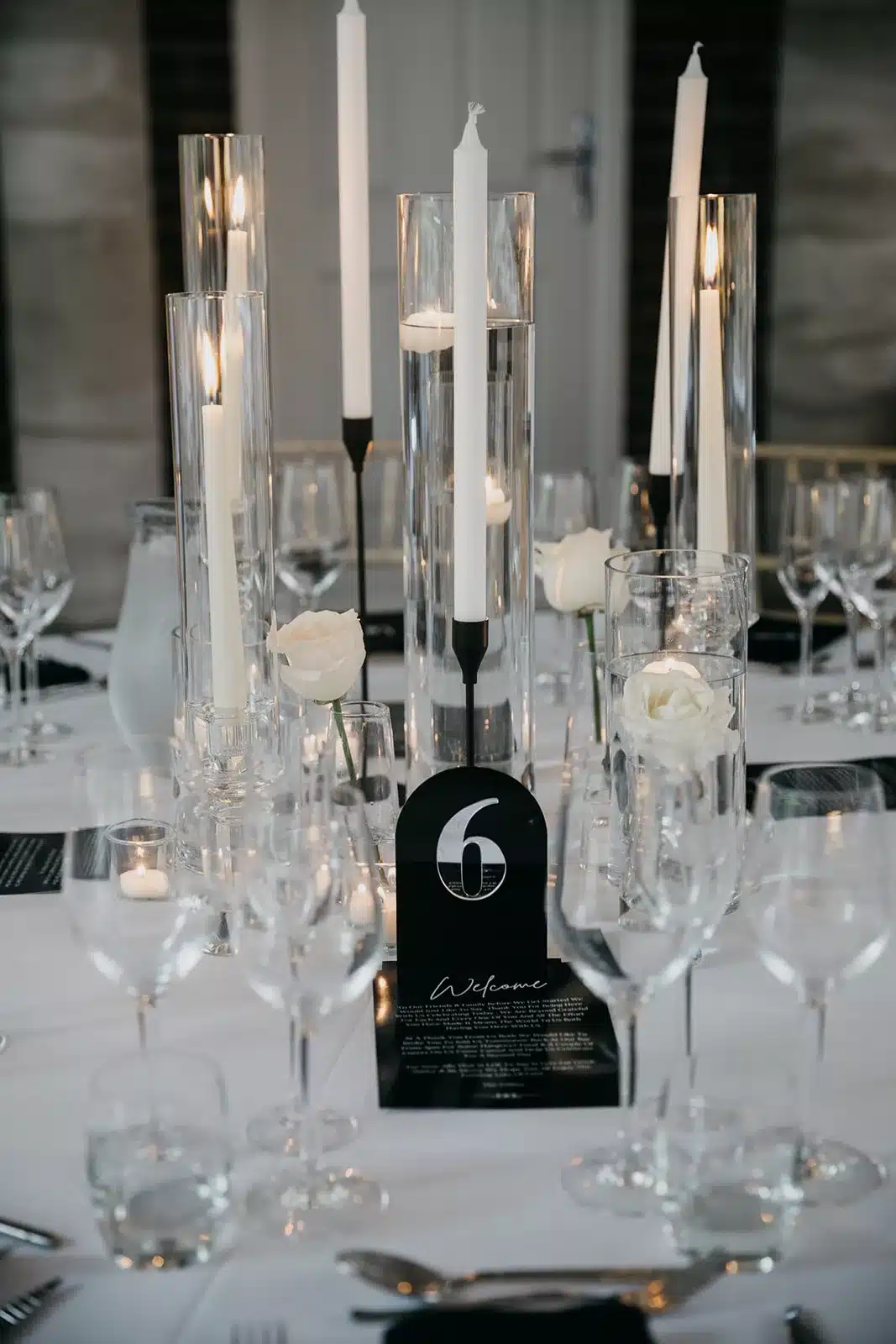 Elegant black and white wedding decor at Delamere Manor, featuring sophisticated table settings, striking floral arrangements, and ambient lighting styled by Thornton Events, creating a timeless and chic atmosphere