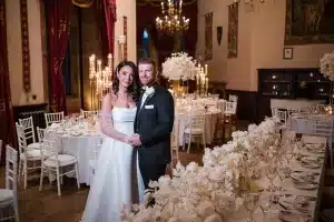 Bride and groom at a beautifully styled wedding reception at Peckforton Castle, featuring elegant wedding decor by a Cheshire wedding stylist.